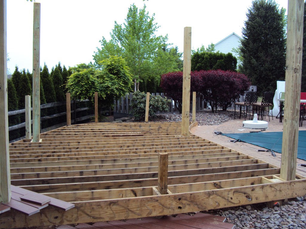 A low deck can be a cost-effective alternative to hardscaping, especially when the framing for a shade structure can be factored into the design.