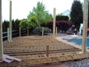 A low deck can be a cost-effective alternative to hardscaping, especially when the framing for a shade structure can be factored into the design.