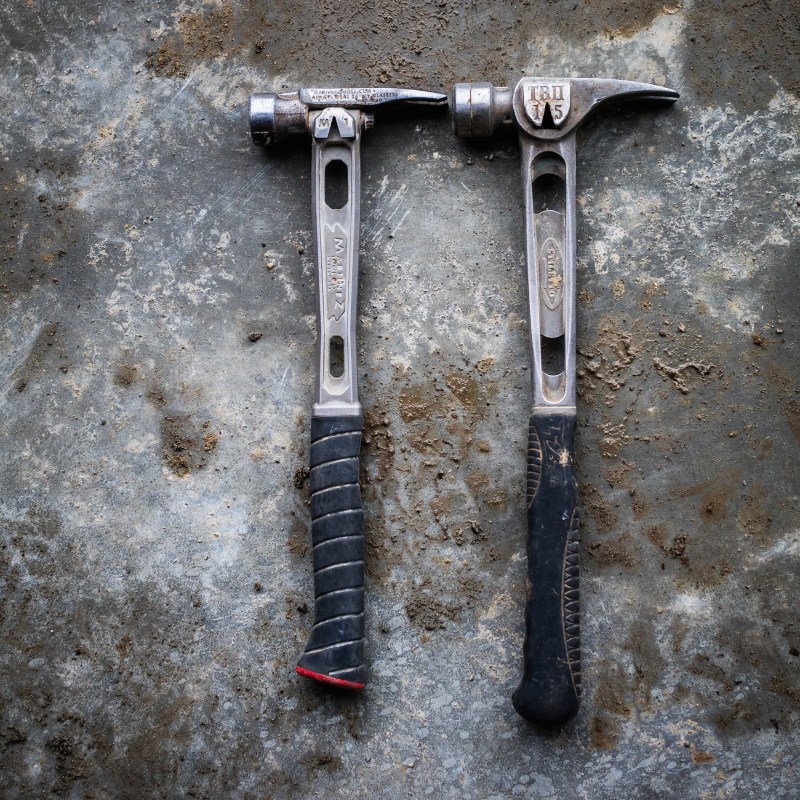 The Martinez M1, left, is slightly smaller than the Stiletto TiBone, right. The M1 comprises an all-titanium handle, replaceable steel head, and replaceable grip. The TiBone is all titanium with a replaceable steel face. The head on the M1 is slightly heavier than the TiBone's, and the smaller size keeps it at 15 oz.