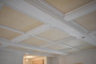 A first cousin of a coffered ceiling, a paneled ceiling is a great way to dress up a room of any size, such as a living room in an open floor plan.