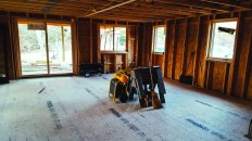 This typical looking building site is anything but typical. What you see is actually the top layer of two layers of OSB sub-flooring. Below the subfloor is a layer of type IX EPS insulation that sits on a structural slab.