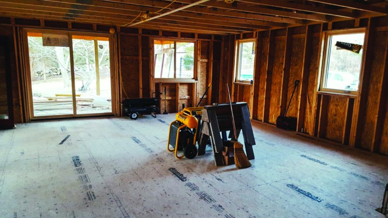 This typical looking building site is anything but typical. What you see is actually the top layer of two layers of OSB sub-flooring. Below the subfloor is a layer of type IX EPS insulation that sits on a structural slab.