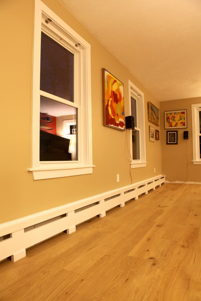 To cover the hydronic baseboard heating elements, these paint-grade covers were fashioned out of factory-primed 1-by pine.