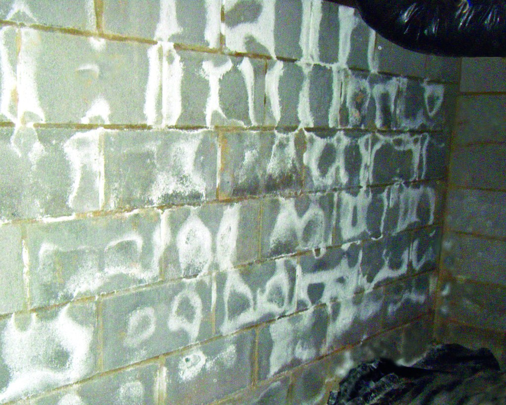 Unsightly salt. White deposits on concrete block are salts that leach from the block as moisture passes through. The deposits don’t do any structural damage to the block, but should be dry-brushed off and thrown away.
