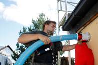 This photo from German equipment maker X-Floc shows the company's dry injection system for cellulose insulation in action. The back-pressure relief valve allows air to escape so that insulation can be uniformly delivered and compacted, while the red filter bag contains dust.