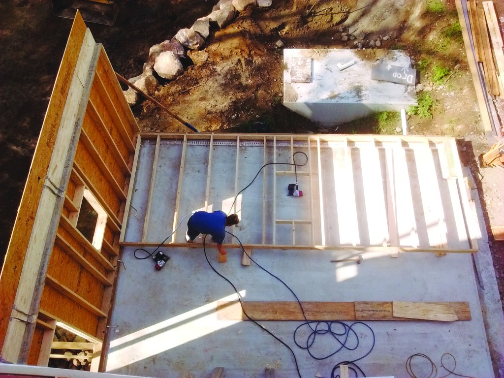 Same openings—different treatments. The openings in the upright wall use a rimboard header, while the nonbearing gable end wall on the slab doesn’t need a header.