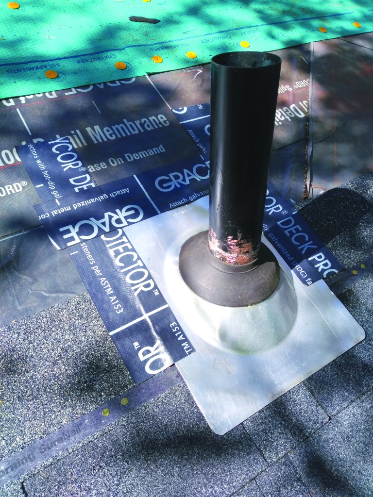 Tape the metal boot to the shingles on the sides and up onto the roof underlayment.