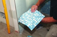 Mesh backing lets you install the tiny glass tiles as a single sheet (1). Start by spreading a thin, even layer of thinset on the wall. Comb the thinset in one direction using a notched trowel with the recommended-size teeth.