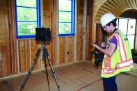 A Multivista technician uses a Matterport scanner and an iPad to create an accurate, photo-realistic virtual model of a Risinger Homes building under construction in 2018.