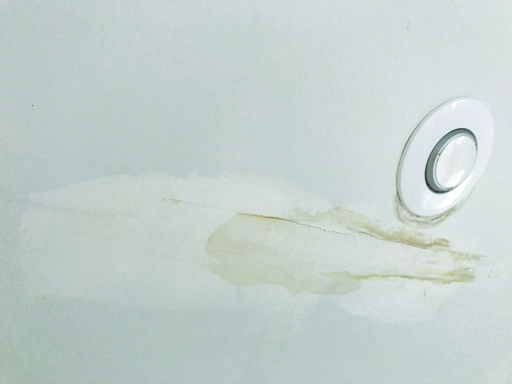 Water stains on the drywall of this cathedral ceiling look like they might have been caused by a roof leak.