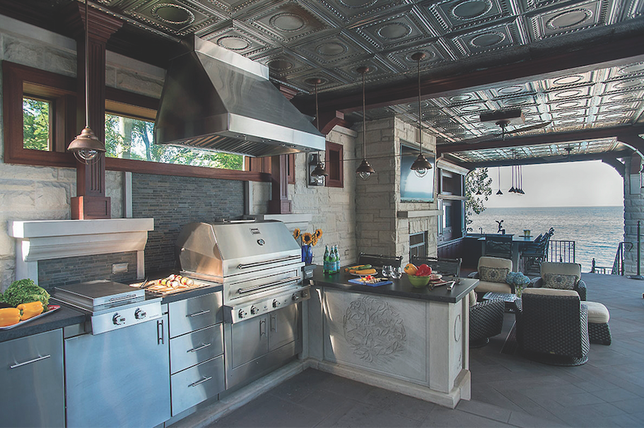 This outdoor cooking area on Chicago's North Shore centers on a combination gas-wood-charcoal grill.