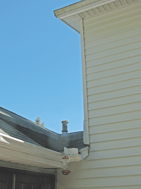 An addition attached to the side of a two-story Colonial created a poorly draining valley, destined to leak. The plumbing vent located in the valley doesn't help.