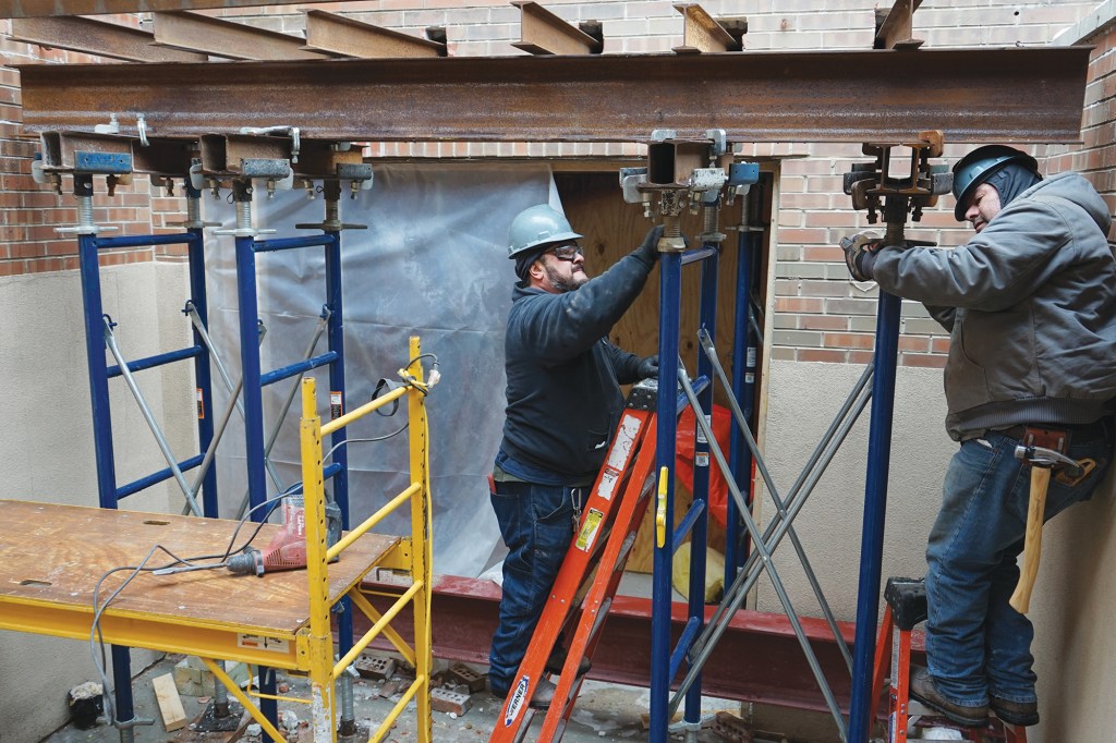 Using the adjustable heads on the shoring towers, we snugged the short beams up against the floor trusses inside the wall and raised the outside towers to the same level (above).
