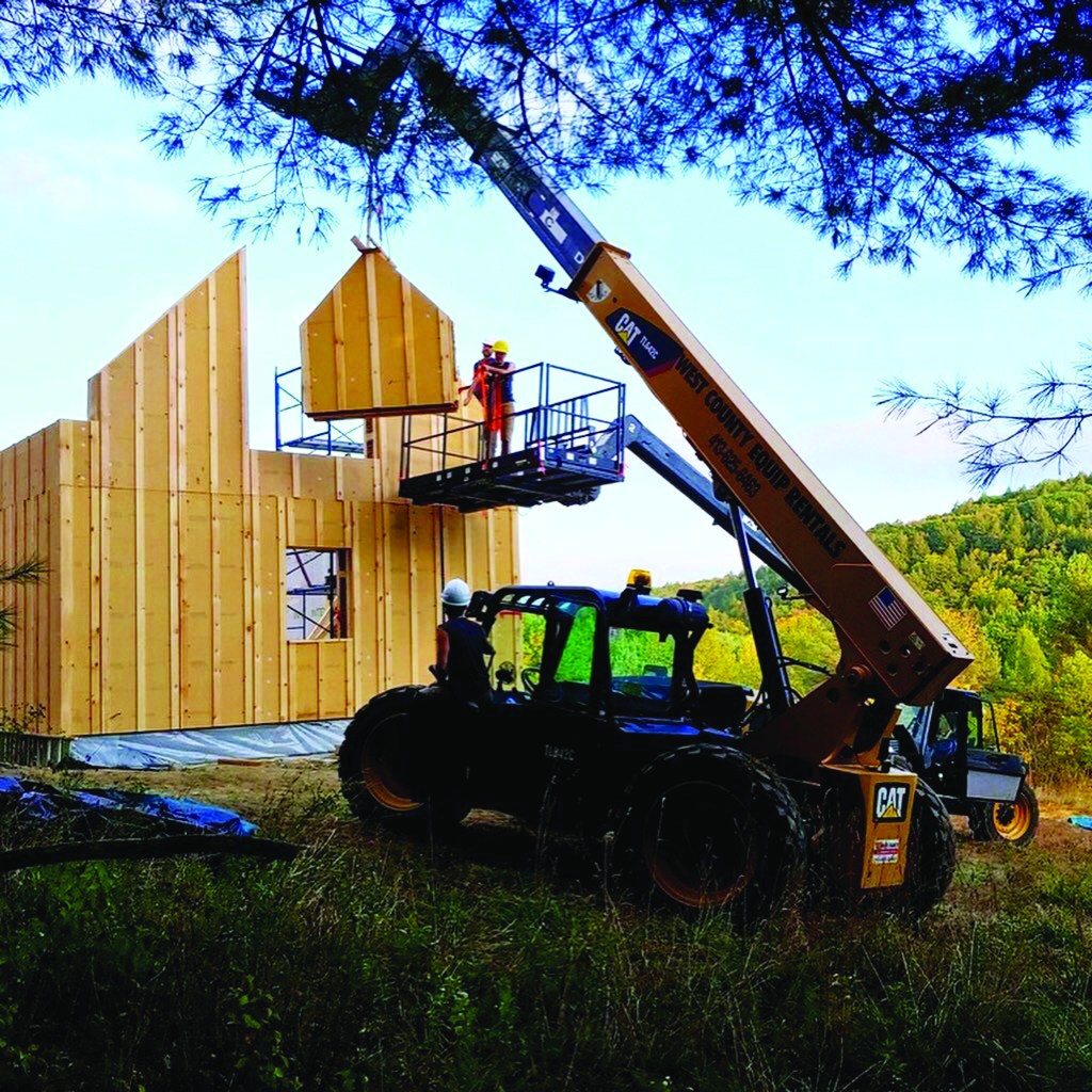 The crew sets straw panels on site in Leyden, Mass.