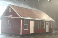 A test house in the IBHS Research Center faces 105-mph wind and torrential rain as Huber Zip System roof sheathing holds water out.