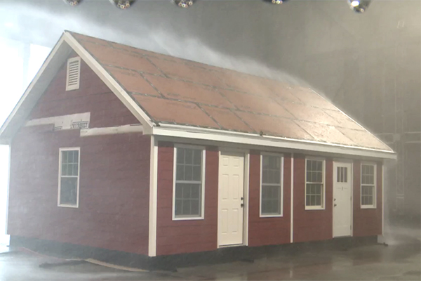 A test house in the IBHS Research Center faces 105-mph wind and torrential rain as Huber Zip System roof sheathing holds water out.