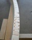 The "valleys" of the  unique tooth pattern are flexible enough to bend and twist. Once clamped and glued, the bent board maintains structural integrity.
