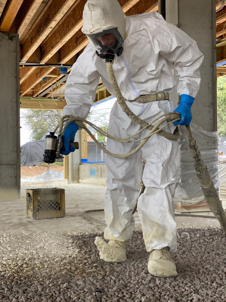 Two inches of closed-cell spray foam provides not only good insulation but also a superior air and water barrier. The author has found that spray foam works best when applied over a compacted crushed-stone base.