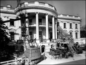Demolition began in late 1949 without fanfare (perimeter fencing was used to hide construction from the public). Steel shoring and debris was passed through openings in the left-intact facade.