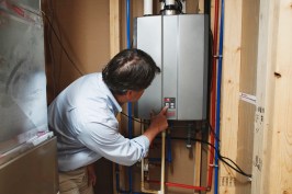 Man inspecting Tankless Hyrdronic heater