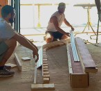 For bending PVC trim, the author builds a box from 2-by stock, sized to fit the heat blankets and lined with cement backerboard. It’s good to have many hands on deck once the heated trim comes out of the “oven” to transfer the heated trim to the form, which the author screws to the subfloor. Blocks define the curve, but it’s important that the form have continuous support front and back to ensure a smooth curve, as the heated trim will conform to the exact contour of the form.