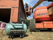 With multiple nail guns in action, the author would typically need to use a gas compressor on this site, but the Metabo HPT EC1315S 8-gallon portable compressor suits his needs perfectly.