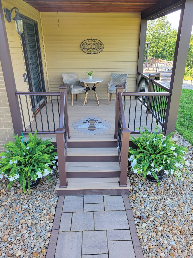 An inlay of a bee made from decking material.