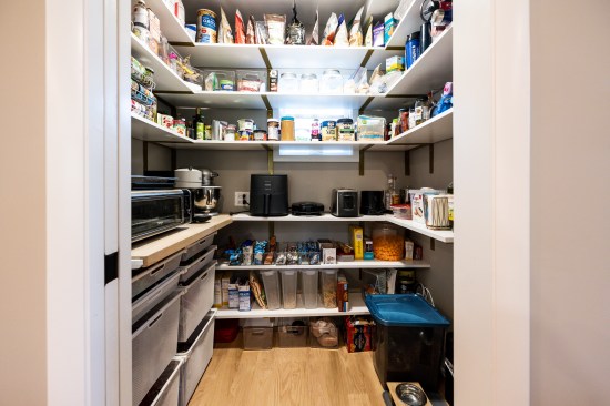A walk-in pantry with plenty of outlets allows kitchen equipment to be used without having to move it and keeps the clutter out of sight when not in use.