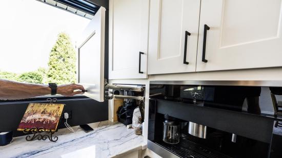 In lieu of a pantry, smart cabinet solutions at the end of counters offer ample storage for bulky kitchen items.