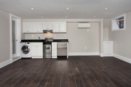 With the structural work complete on the first floor, we moved on to the other floors, juggling the clients (who stayed in the house during construction) from space to space. The finished basement, though small, looked pretty slick.