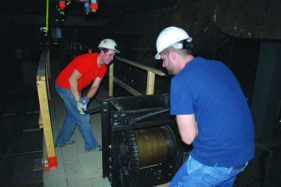 The chandelier was attached to a permanent heavy-duty, gear-reduction winch assembly. We just needed to disconnect the wiring and carefully hand-crank the fixture to the floor.
