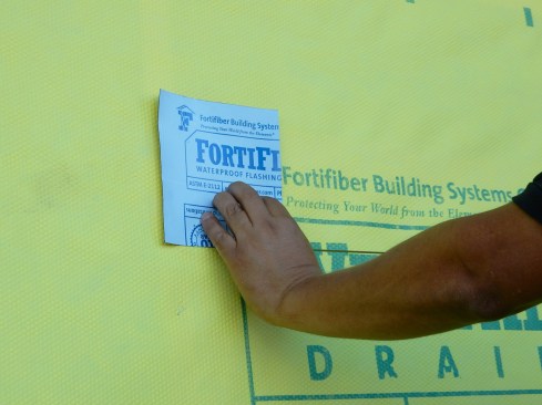 Step 1 (cont.). Cut Housewrap/WRB.Head laps should be cut at a 45-degree and to the width of the head and side flashing—no more, no less. A simple trick is to use a square, scrap piece of flashing as a template to help correctly mark outer edge of cut.