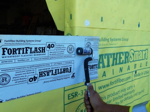 Step 3. Apply Sill Pan Flashing. Install the self-adhered flashing (SAF), starting at the sill. Each end of the sill flashing should extend at least 9 inches (the width of the flashing material) beyond the opening so the side flashing can fully lap over it. Roll the SAF flat with a J-roller.