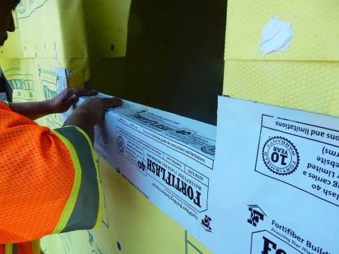 Step 3 (cont.). Apply Sill Pan Flashing.Cut the SAF and fold down on to the RO’s sill. Note: If a cementitious cladding, such as stucco, or brick or stone veneer, is planned for the house, install a through-wall flashing apron first under the self-adhered pan flashing. This will ensure that water drains to the exterior.