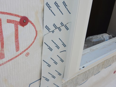 Poorly adhered flashing is common. The SAF is often applied with hand-pressure only, not properly J-rolled. This means the flashing does not have an even, flat surface to stick to. Air gaps and wrinkles develop under the flashing. And, if the weather is cold or wet, adhesion problems develop as well. These can lead to even worse problems if the flashing has not been shingled properly. Install continuous-length flashing, if possible. If not, do not reverse lap the SAF as seen in this photo. With a drainable housewrap, water can migrate laterally much easier than if the housewrap is not drainable.
