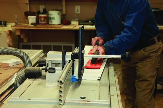 For cutting the face miters—when the board is lying flat on the table as it’s cut—the hold-down device on this CMS stand helps control and stabilize the work as it is pushed through the cutter.