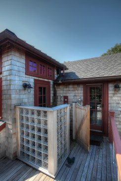 While the majority of outdoor shower enclosures are wooden, materials for building an outdoor shower are limited only by the imagination. Glass block was used for this outdoor shower to let more light into the enclosure.