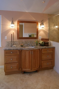 Actual light fixtures can be as important as the light they are creating. Install light fixtures that are on trend and also provide pleasing light, such as the re-purposed exterior fixtures over this bathroom vanity that create an attractive design touch without adding much cost.