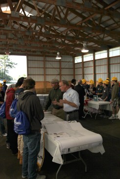 At a Career Day station inside, building officials Victor Staley and Patrick Franey explain to a group of students the importance of the role that inspectors and code officials play in the building industry.