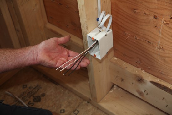 After pushing the twisted grounds to the back of the box, the conductors are all cut to a length of about 8 inches. 
