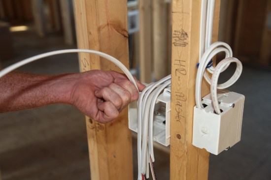 Cables fed from below the box are treated in the same manner. Here the author gauges where to begin stripping the outer jacket.