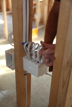 The author feeds the cables into the switch box leaving a loop in each one. Again the loop provides extra cable in the event that one of the conductors is damaged during the drywall installation.