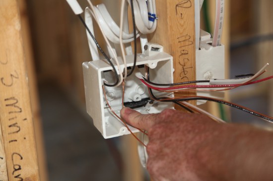 After roughly sorting the conductors for each of the switches, the author pushes the grounds for one switch into the back corner to give them plenty of slack for bundling. 