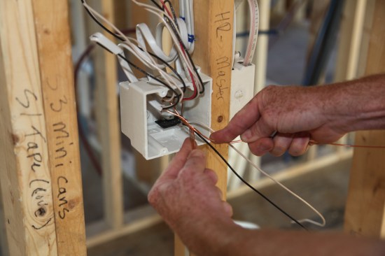The author makes a half dozen twists by hand marrying together the ground conductors from all five cables.