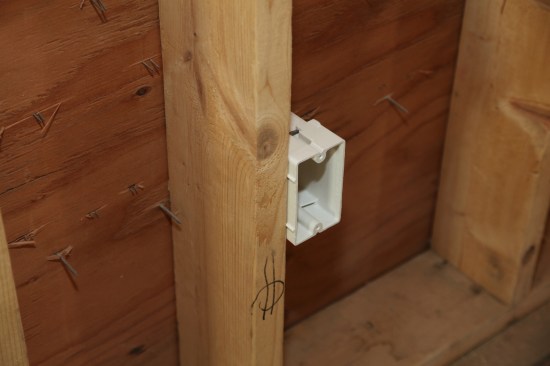 Small plastic nubs on the sides of the electrical box sets it at the proper depth for the drywall.