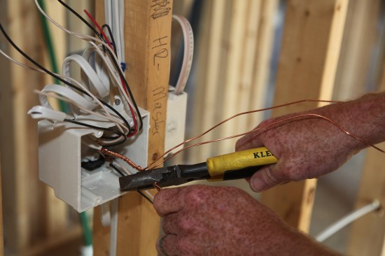 The author cuts all of the ground conductors but two--one for each switch.