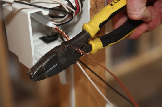 A special crimping jaw on the pliers collapses and tightens the sleeve to secure the grounds together. 