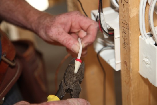 Use pliers to make a final twist of the wire nut, but take care not to over-tighten the nut. After attaching the wire nuts push the neutral bundles into the back of the box.