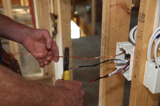 The final step is cutting off excess cable before rolling, folding and pushing each group of conductors into the box as far as possible.