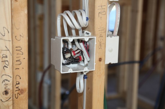 The finished box with all the conductors and bundles pushed as far into the box as possible. Labels still attached to the conductors will let the crew member wire the switches quickly and efficiently. 